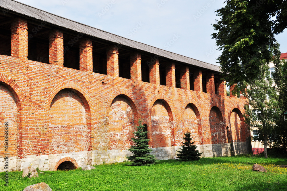 The old brick wall of the Smolensk Kremlin. Fragment of a wall with a red brick passage. Smolensk, Russia.