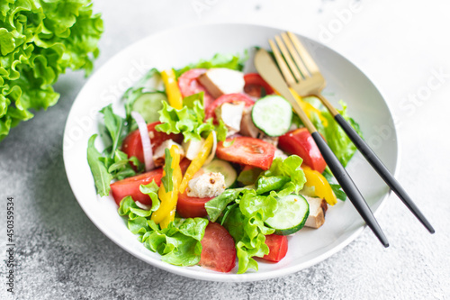 salad fresh vegetables lettuce leaves tomato, cucumber, onion, pepper outdoor meal snack on the table copy space food background rustic. top view keto or paleo diet veggie vegan or vegetarian food