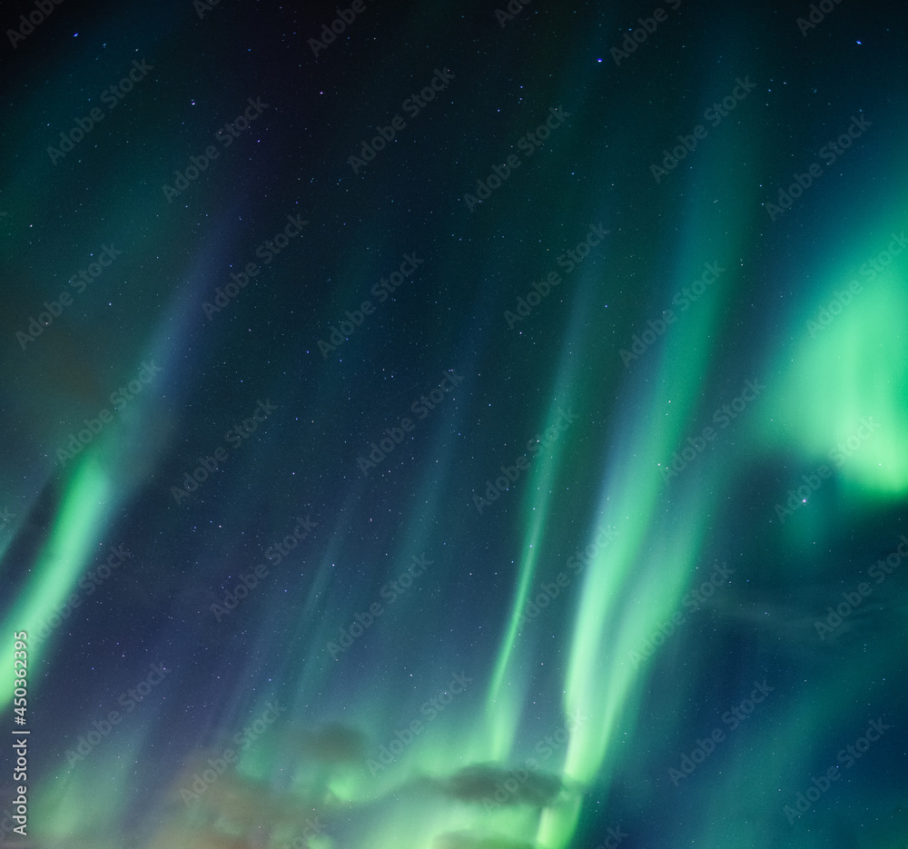 Aurora borealis, Northern lights with stars glowing in the night sky ...