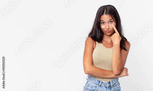 pretty thin hispanic woman keeping an eye on you watching and staying alert