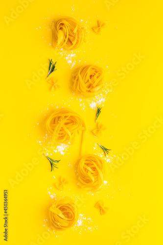 Different tipes of pasta with flour ready for cooking, flat lay photo