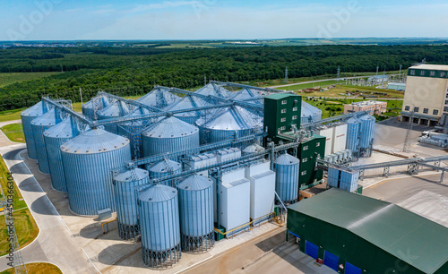Warehouse granary aluminum containers. Grain silo and parking place. Steel grain elevators. Agriculture Industry. High angle view