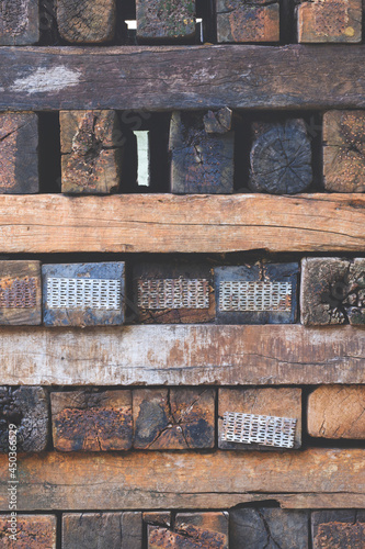 Background of many old railroad ties or wooden sleepers stacked in vertical frame 