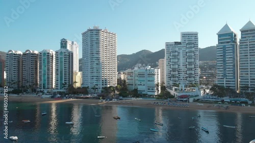 Beautiful view of the beach, aerial view of the beach, acapulco beach seen from above. Travel and vacation concept. Colorful sunset on the beach. Aerial video