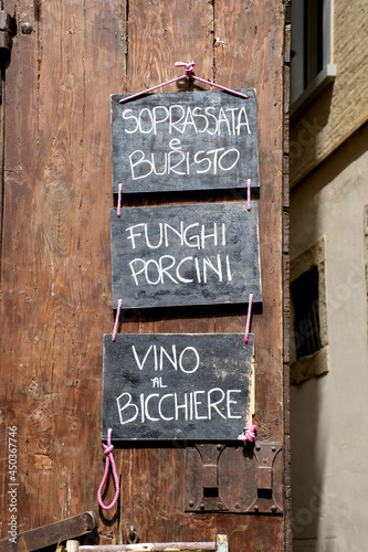 Vintage sign menu on the black board with a list of Tuscan and Italian typical food