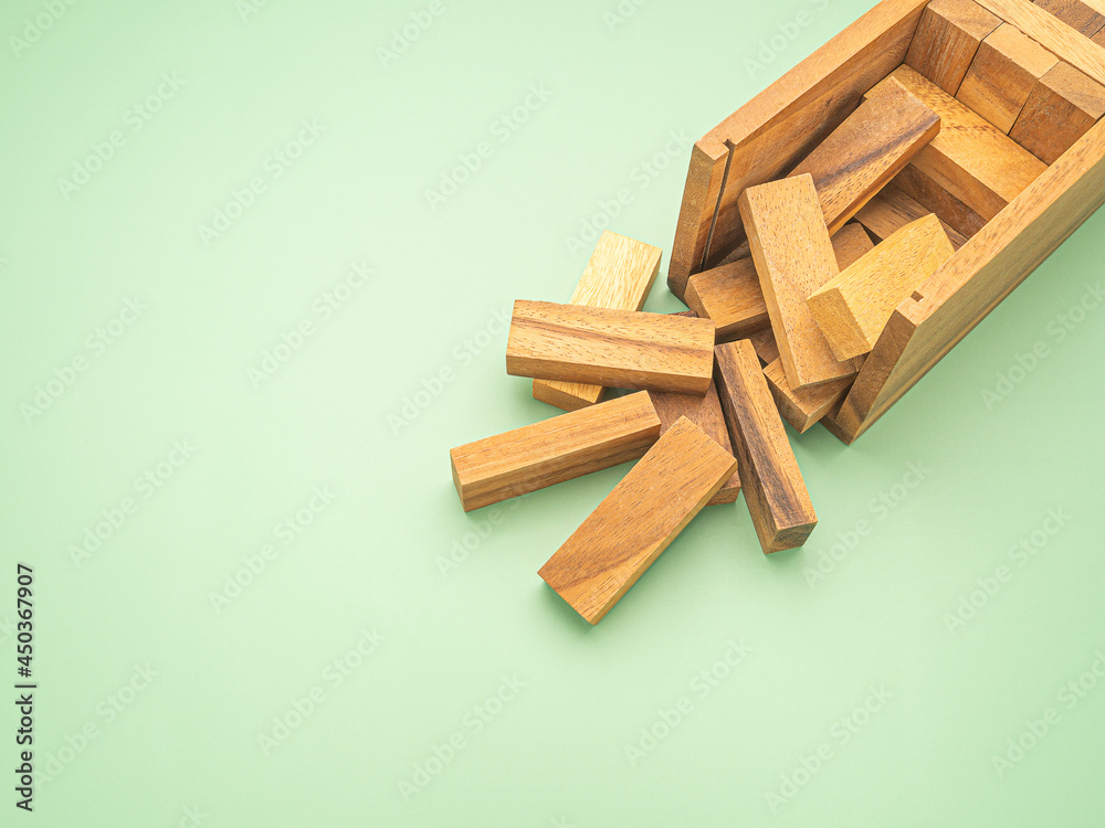 Table game made of wooden blocks isolated on a green background. Space for text Table game made of wooden blocks isolated on a green background. Space for text