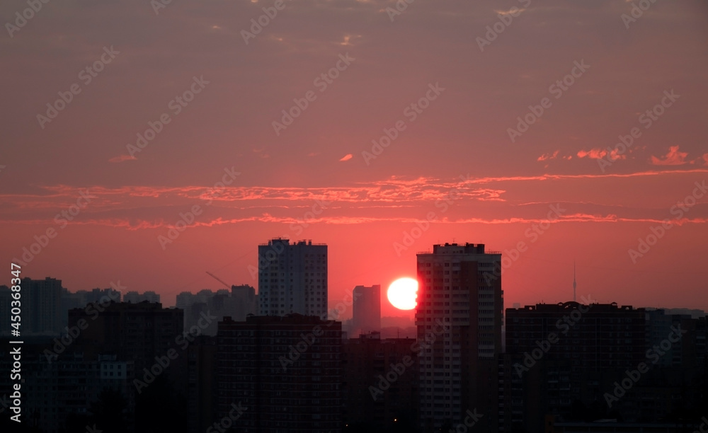 Sunrise over the city. The sun rises above the horizon