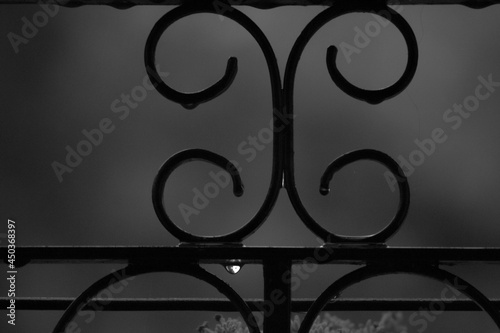 water drop hanging from a railing