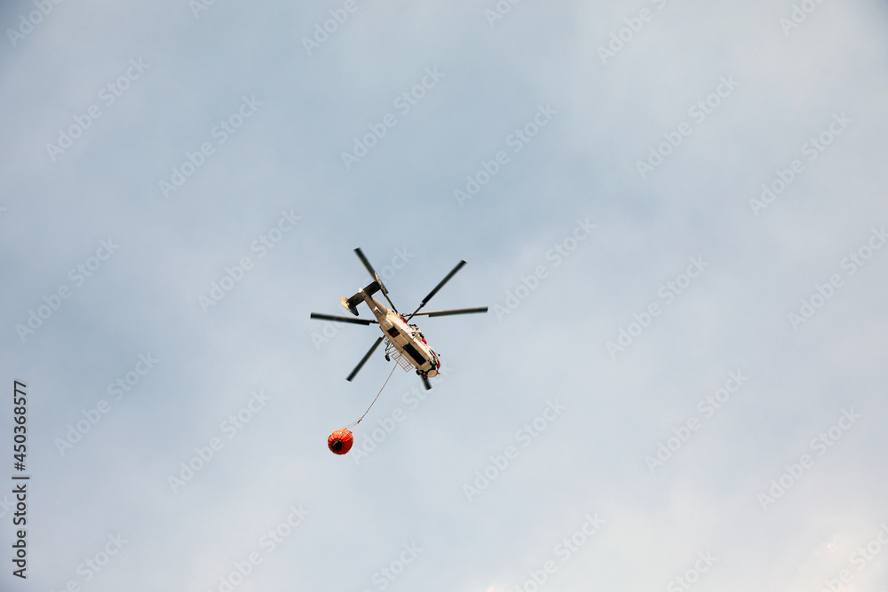 fire fighting helicopter leaves water to the forest fire fire fighting helicopter leaves water to the forest fire