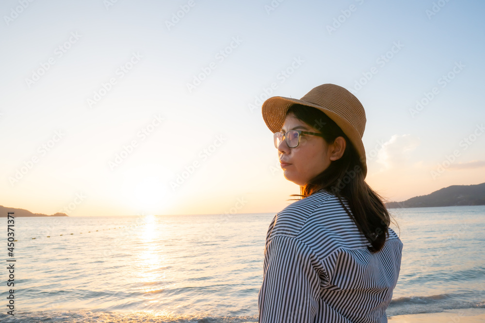 woman on the beach and sunset in the sea woman on the beach and sunset in the sea