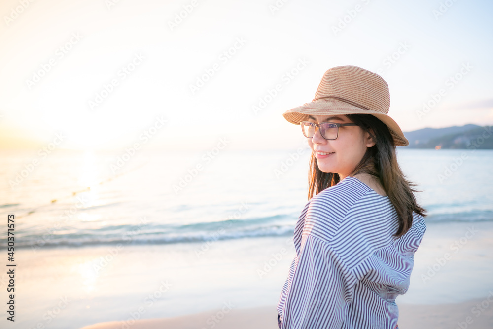 woman on the beach and sunset in the sea
