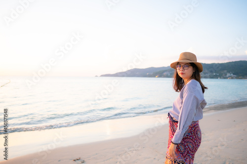 woman on the beach and sunset in the sea