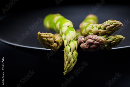 Jiant asparagus isolated on black