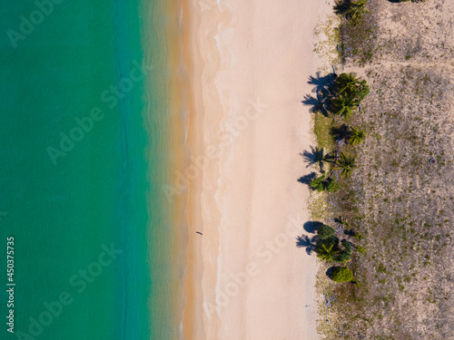 Aerial view high angle view Top-down seawater wave on sandy beach. Aerial view above beach sea in tropical beach sea.