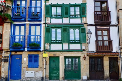 Vibrant buildings with windows and balconies of different colours downtown in Hondarribia, Basque Country, Spain photo