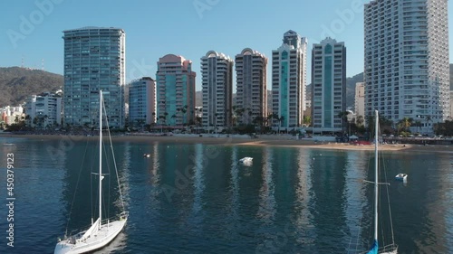 Beautiful view of the beach, aerial view of the beach, acapulco beach seen from above. Travel and vacation concept. Colorful sunset on the beach. Aerial video