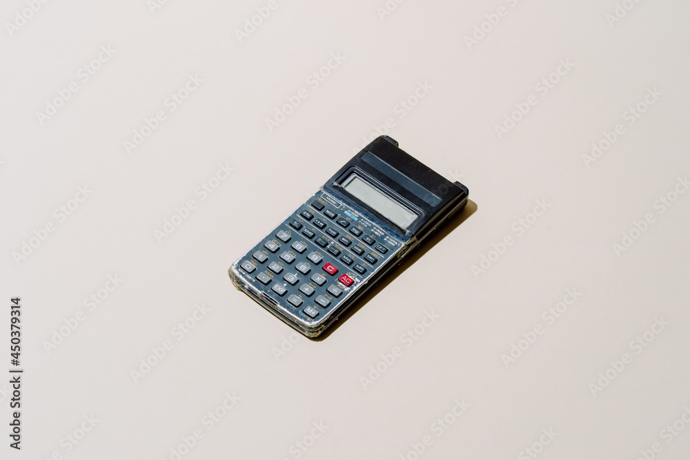 Digital school calculator in study background Digital school calculator in study background