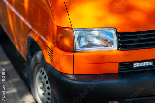 Headlight of an old car close up. Orange van.