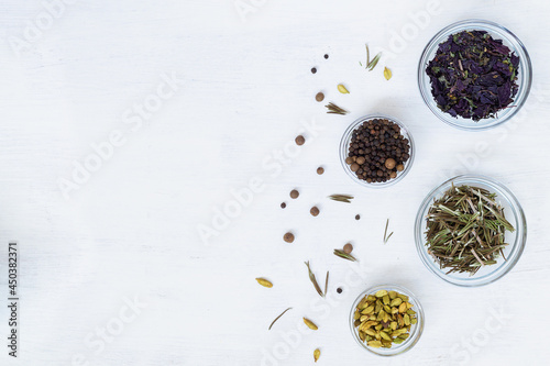 spices on a wooden table.dry spices for cooking. food ingredients on the white table. flat lay background with herbs, spices with copy space. top view.