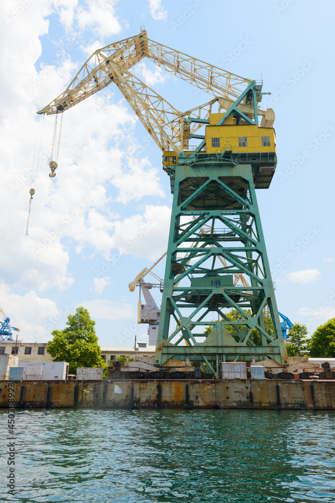 Sea port crane on the seashore on a sunny day