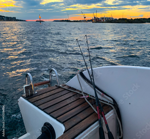 Fishing Polls On The Back of A Boat During Ocean Sunset. Vacation Concept