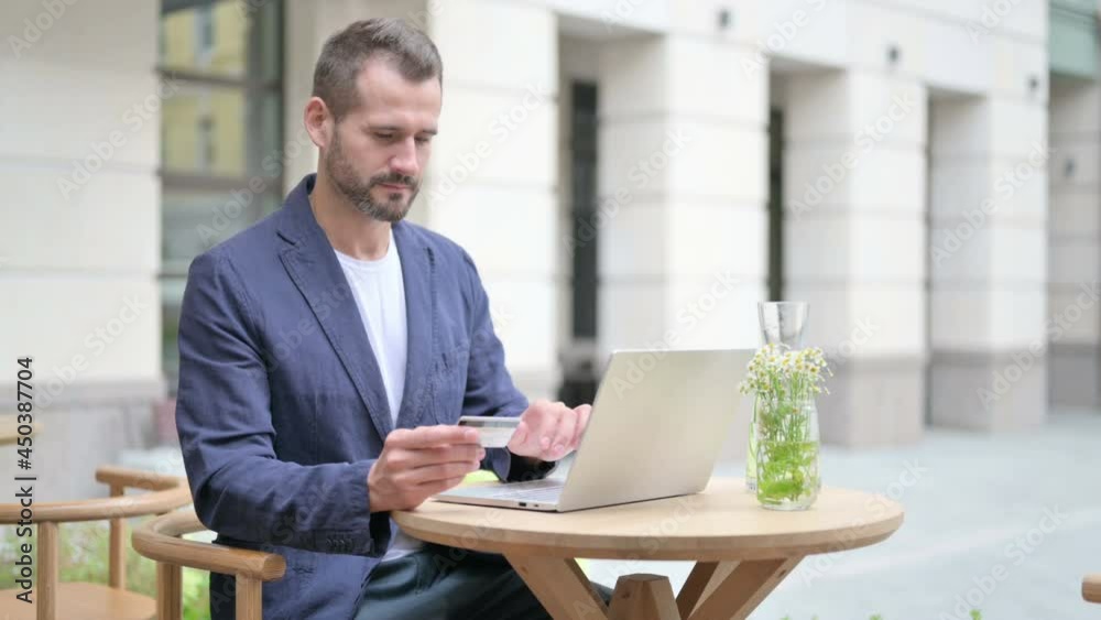 Man making Successful Online Payment on Laptop Man making Successful Online Payment on Laptop