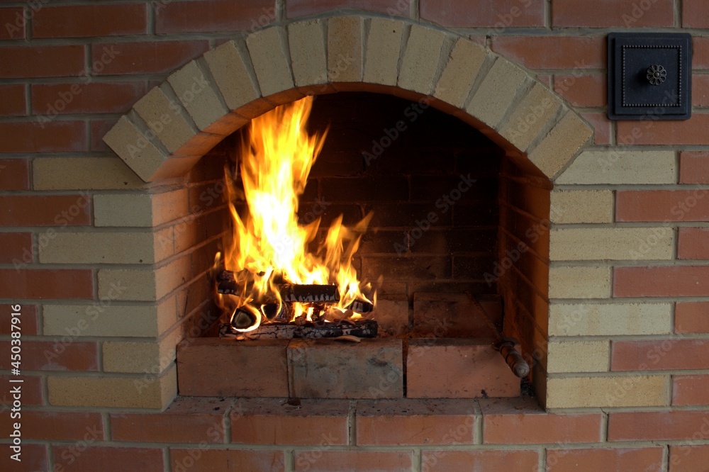 Stone fireplace with burning wood and bright tongues of flame. Stone fireplace with burning wood and bright tongues of flame.