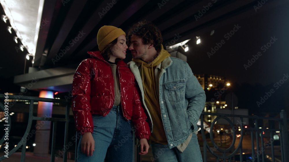 Lovely couple looking eyes to eyes on city background. Pair kissing on street.