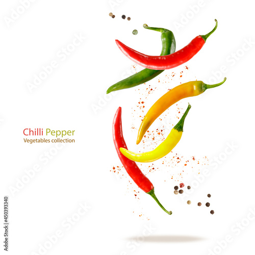 Flying red, orange, green and yellow chilli peppers