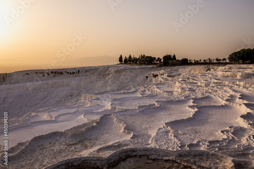 Pamukkale carbonate mineral field at sunset