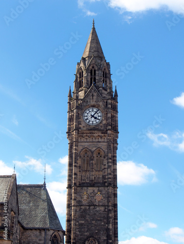 the tall clock tower of historic 19th century rochdale town hall in lancashire with blue summer sky and white clouds photo