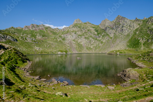 hiker on Lac Bersau, Ayous lakes tour, Pyrenees National Park, Pyrenees Atlantiques, France