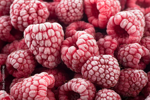 Berries background - Frozen raspberries covered with hoarfrost. Summer berries  top view.