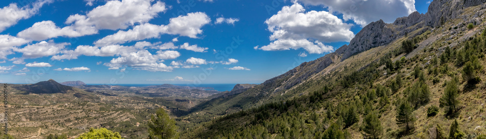 panoramic view coast, mountains and a beatiful sky since bernia mountain. mediterranean coast landscape located in the Valencian Community, Alicante, Spain