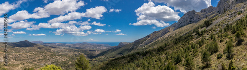 panoramic view coast, mountains and a beatiful sky since bernia mountain. mediterranean coast landscape located in the Valencian Community, Alicante, Spain