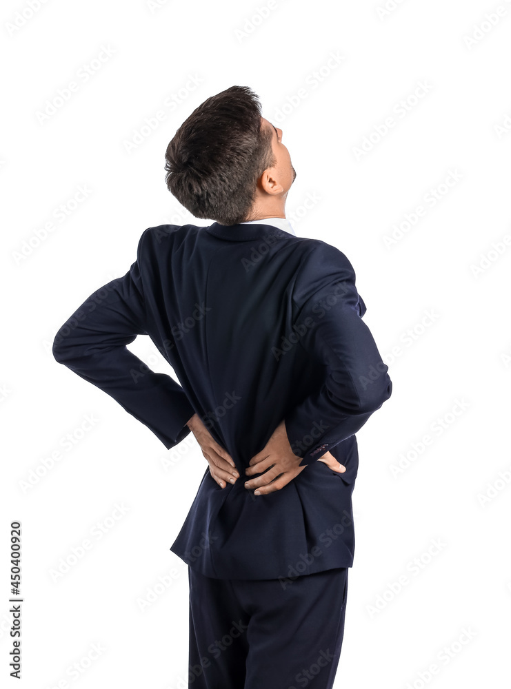 Young businessman suffering from back pain on white background Young businessman suffering from back pain on white background