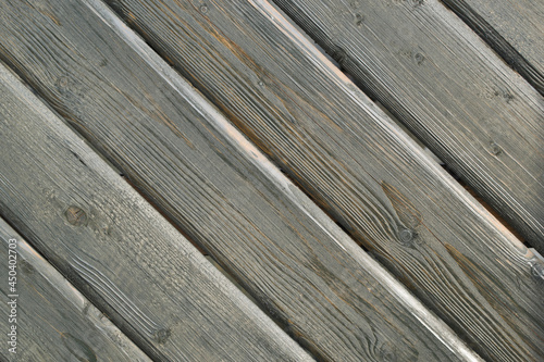 Texture. Part of an old wooden door with boards at an angle.