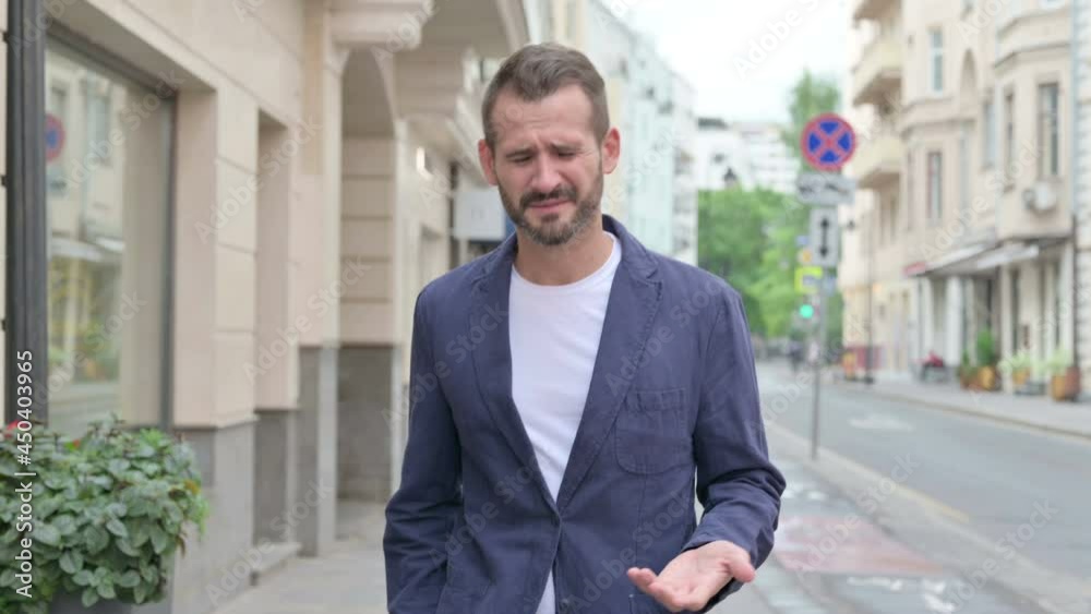 Mature Adult Man Feeling Sad while Walking Down the Street Mature Adult Man Feeling Sad while Walking Down the Street