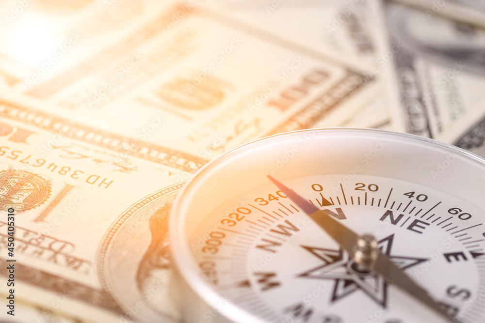 Travel compass on the background of American dollars Travel compass on the background of American dollars