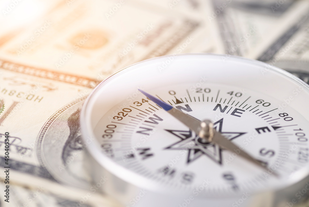 Travel compass on the background of American dollars Travel compass on the background of American dollars