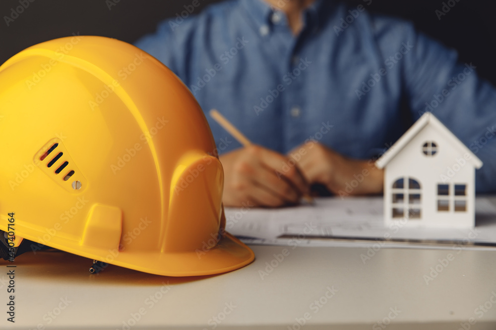 Architect engineer working on blueprint at his office Architect engineer working on blueprint at his office