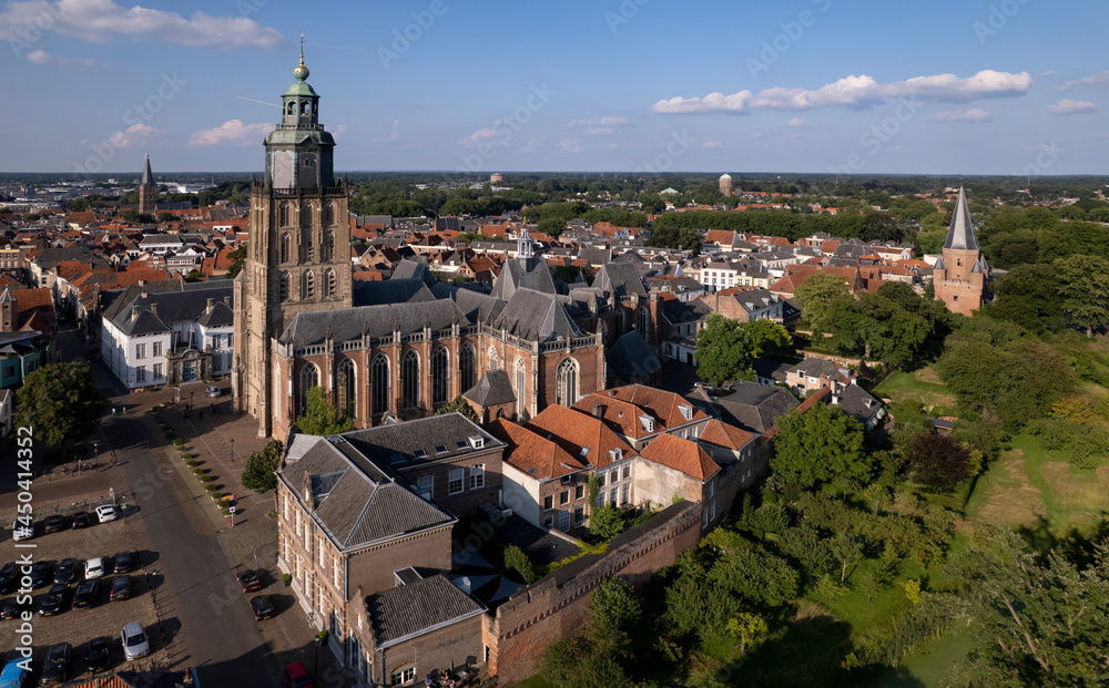Walburgiskerk cathedral and Drogenapstoren along medieval Hanseatic city wall of tower town Zutphen in The Netherlands seen from above at sunset. Aerial Dutch urban cityscape.