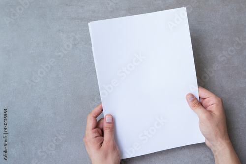 Male hands holding blank white paper