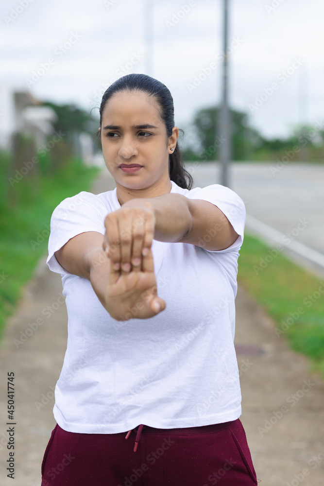 Latin Woman Doing Right Arm Finger Stretch Latin Woman Doing Right Arm Finger Stretch
