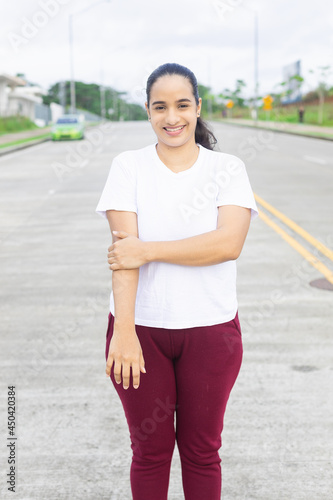 latin woman standing on the street