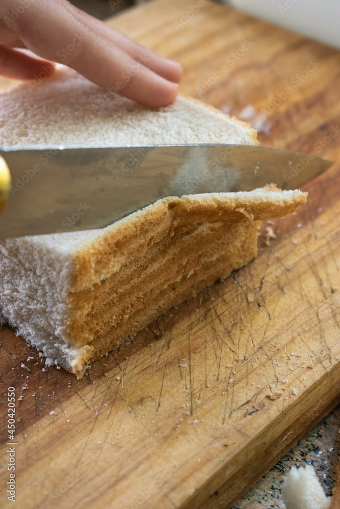 Cutting bread on a wooden board Cutting bread on a wooden board