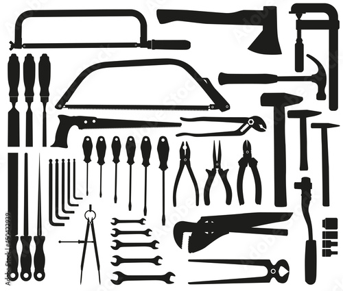 Vector set of hand tools as black silhouettes on white background. Hammer, screwdriver, pliers, clamp, saw, chisel