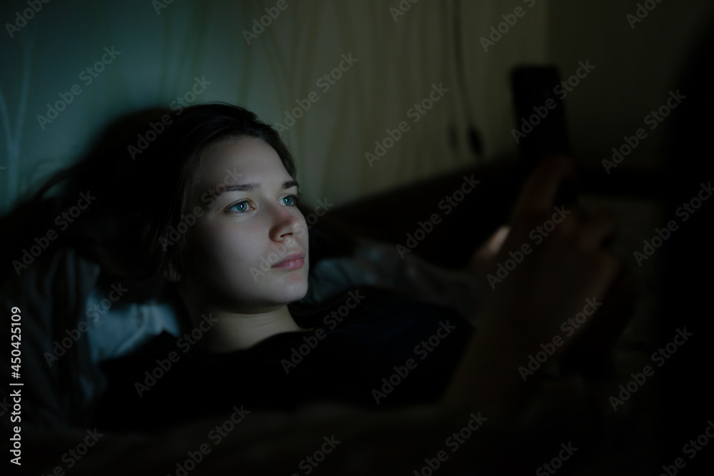 Women are using the smart phone on the bed before she sleeping at night. Mobile addict concept Women are using the smart phone on the bed before she sleeping at night. Mobile addict concept