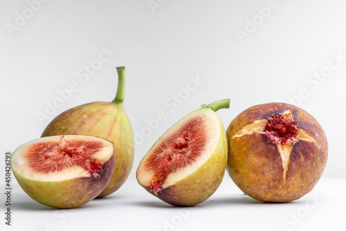 White background photo of figs cut in half. photo