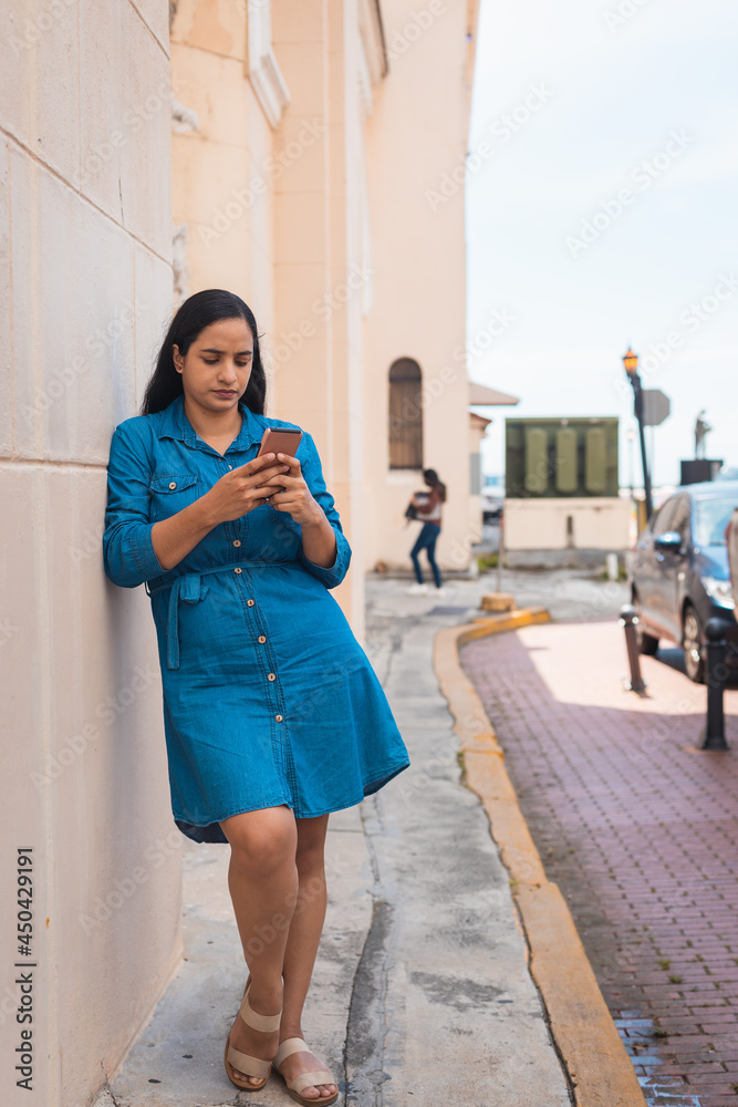 woman walking to the sidewalk, looking at the cell phone woman walking to the sidewalk, looking at the cell phone